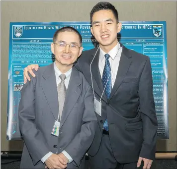  ??  ?? Austin Wang, right, poses with his father Hopkins Wang after winning a top award at the Internatio­nal BioGENEius Challenge in Philadelph­ia.