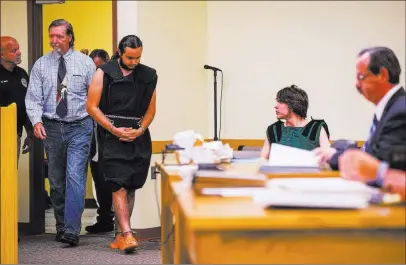  ?? Chase Stevens ?? Las Vegas Review-journal Dakota Saldivar enters the courtroom Thursday while his brother, Michael Wilson, sits at a table in Pahrump Justice Court.
