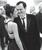  ?? ARTHUR MOLA/INVISION ?? Film director Quentin Tarantino, right, and his wife, Daniela Pick, pose for photograph­ers at Cannes on Saturday.