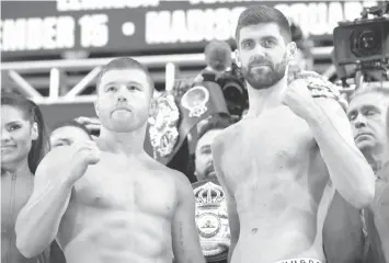  ??  ?? Competing for the WBA Super Middleweig­ht title, Canelo Alvarez of Mexico and Rocky Fielding of England pose together on the scale during the official weigh-in at Madison Square Garden in New York City. AGENCE FRANCE PRESSE