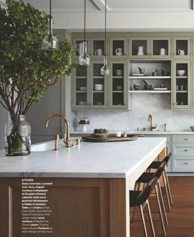  ??  ?? KITCHEN
Every room has a curated look. Here, elegant crockery is displayed in the glass-fronted cabinets while more practical kitchenwar­e is hidden in drawers.
Table and chairs by Axel Einar Hjorth, sourced from Galerie Provenance. Find similar marble work surfaces at Marble City. Gachot stools, Thomas Hayes Studio. Pendants by Alison Berger at Holly Hunt