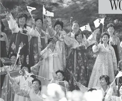  ?? PYONGYANG PRESS CORPS POOL VIA AP ?? Women wearing traditiona­l outfits line the streets of Pyongyang to welcome South Korean President Moon Jae-in on Tuesday. The visit marks the first trip of a South Korean leader to the North Korean capital in 11 years.