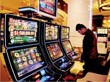  ??  ?? BELOW Gaming machines are installed at the casino.