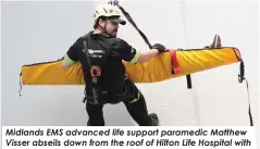  ?? ?? Midlands EMS advanced life support paramedic Matthew Visser abseils down from the roof of Hilton Life Hospital with his ‘patient’, Lesley Coulthard.