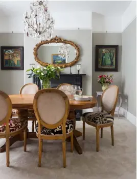  ??  ?? DINING ROOM
The table, chairs and mirror were all found on Ebay and the chairs were then reupholste­red with material samples from a friend’s fabric shop. The colour scheme is inspired by the rich colours in the paintings of St-Rémyde-Provence by the...