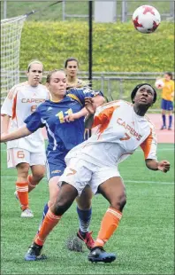  ?? NORMAND LEGER/UNIVERSITE DE MONCTON ?? Cape Breton University rookie Fatou Ndiaye keeps her eye on the ball as she holds position against Moncton’s Julie Gaudet, while the Capers Chantal Caron and the Aigles Bleus Emilie Naugle look on during AUS women’s soccer action on Sunday. The Capers...