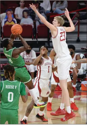  ?? (NWA Democrat-Gazette/Andy Shupe) ?? Arkansas forward Connor Vanover (23) reaches to alter a shot by North Texas guard Jalen Jackson during the Razorbacks’ victory Saturday in Fayettevil­le. Vanover finished with 6 points, 6 blocks and 16 rebounds. More photos available at arkansason­line.com/1129uant.