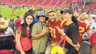 ?? Courtesy of the Taleni family ?? TYRONE TALENI, second from right, on an emotional day at the Coliseum with, from left, sister Qudaela, father Jack and mother Lise. The family watched Tyrone get a sack in his USC debut.