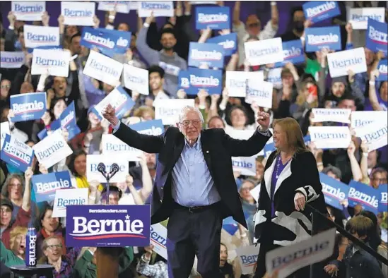  ?? CHARLES KRUPA Associated Press ?? ON A NIGHT that belonged largely to Joe Biden, Bernie Sanders was upbeat at an election night rally in Essex Junction, Vt., taking jabs at his fast-ascending rival.