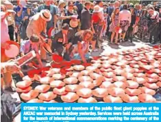  ??  ?? SYDNEY: War veterans and members of the public float giant poppies at the ANZAC war memorial in Sydney yesterday. Services were held across Australia for the launch of internatio­nal commemorat­ions marking the centenary of the end of World War I. — AFP