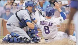  ?? Jonathan Daniel
Getty I mages ?? A. J. ELLIS of the Dodgers tags Chris Coghlan of the Cubs for the f inal out of the fourth inning. Alex Guerrero made the throw from left f ield.