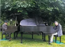  ?? Paul Chinn / The Chronicle ?? Dean Mermell (left) and Bobby Franz perform an impromptu duet at the Flower Piano event.