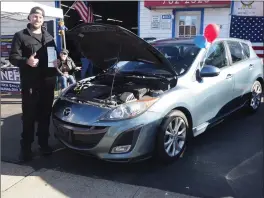  ?? ?? Burrillvil­le’s Seth Guy, a U.S. Army infantry veteran, stands with his Mazda donated by New Englanders Helping Our Veterans with work done by Henri’s.