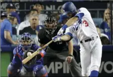  ??  ?? Los Angeles Dodgers’ Chris Taylor hits a home run against the Chicago Cubs during the sixth inning of Game 1 of baseball’s National League Championsh­ip Series on Saturday. AP PHOTO/ALEX GALLARDO