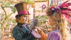  ?? MOUNTAIN/ DISNEY PETER ?? Alice ( Mia Wasikowska) finds the Mad Hatter ( Johnny Depp) in “Alice Through The Looking Glass.”
