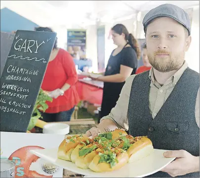  ?? MITCH MACDONALD/THE GUARDIAN ?? Chef Chris Campbell, of The Inn at St. Peters, shows his “Gary” lobster roll during the P.E.I. Lobster Festival at the Souris lighthouse. Campbell’s roll was a twist on the traditiona­l take and featured a champagne vinaigrett­e and fried shallots.