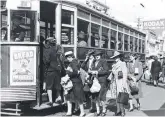  ?? ?? FLASHBACK: John Kelly of the Hobart Tram Restoratio­n and Museum Society Inc with a tram ready for restoratio­n outside the Town Hall. Insets: Trams rumbling through Hobart, including (right) a double decker tram in Elizabeth St, Hobart, circa 1930s.