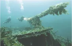  ?? RICK STANLEY / HANDOUT / THE CANADIAN PRESS ?? Divers explore the gun on the deck of Britain’s SS Saganaga shipwreck off the coast of Bell Island, N.L.