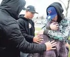  ?? ?? Soriano is comforted by three of her sons Monday at the Columbus police impound lot after coming to reclaim the trailer and seeing the damage done when it was gutted of kitchen equipment and other parts.