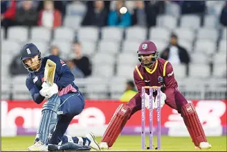  ?? (AFP) ?? England’s Jonny Bairstow plays a shot as West Indies’ Shai Hope keeps wicket during the first One-Day Internatio­nal
(ODI) cricket match between England and the West Indies at Old Trafford, Manchester on Sept 19.