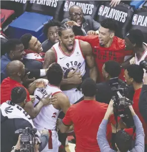  ?? Nathan Denette/The Canadian Press ?? Kawhi Leonard is mobbed by teammates after his buzzer-beater defeated the Philadelph­ia 76ers. The Raptors star may be the best profession­al athlete ever to play in Toronto.