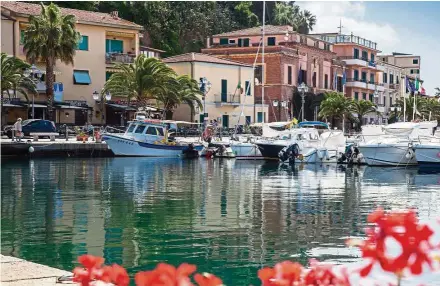  ??  ?? Pleasure and fishing boats share the harbor at Porto Azzurro, on Elba Island, Tuscany coast, Italy.