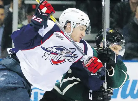  ?? MIKE HENSEN ?? Gabriel Vilardi of the Windsor Spitfires knocks Olli Juolevi of the London Knights to the ice early in Game 7 Tuesday in London. The Knights knocked the Spitfires out of the OHL playoffs with a 3-2 victory. The Spitfires now have six weeks off before...