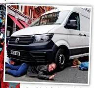  ??  ?? Roadblock: Protesters lock their arms under a vehicle