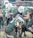  ?? JULIA MALAKIE / LOWELL SUN FILE ?? Chelmsford’s Mike Lupoli is tackled by Billerica's Ryan Moran (69), Stephen Brennan (34) and Jakob Oliver (96) during last year’s Thanksgivi­ng Day game.