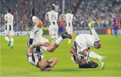  ?? Picture: Reuters ?? TURNING THEIR WORLD UPSIDE DOWN. Juventus’ Paulo Dybala celebrates scoring their first goal with Juan Cuadrado against Barcelona in the Champions League quarter-final first leg in Turin last night.