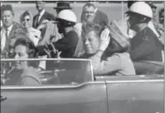  ?? JIM ALTGENS, FILE - THE ASSOCIATED PRESS ?? In this Nov. 22, 1963, file photo, President John F. Kennedy waves from his car in a motorcade in Dallas. Riding with Kennedy are first lady Jacqueline Kennedy, right, Nellie Connally, second from left, and her husband, Texas Gov. John Connally, far...