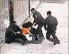  ??  ?? Cops subdue suspect who stole Tasers and zapped three of them.