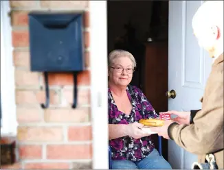  ?? Associated Press photo ?? In these undated photos, Meals on Wheels America volunteers deliver a meal to homebound seniors in Trenton, N.J. From ride-sharing apps to grocery deliveries, digital door locks to “smart” medicine dispensers, more help than ever is out there to help people live safely and comfortabl­y in their own homes as they get older.