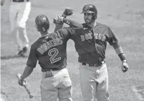  ?? JULIO CORTEZ/ASSOCIATED PRESS ?? The Red Sox’s J.D. Martinez, right, is greeted near home plate by Xander Bogaerts after hitting a solo home run off Orioles starting pitcher Jorge Lopez during Sunday’s game in Baltimore.