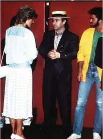  ??  ?? In this July 13, 1985, Britain's Princess Diana meets singers Elton John, center, and George Michael, right, on her arrival at Wembley Stadium in London for the Live Aid famine relief concert for Africa.