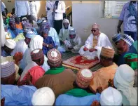  ?? (AP/Jossy Ola) ?? Babagana Umara Zulum (center) governor of Borno state, prays Sunday during a funeral for those killed by suspected Boko Haram militants in Zaabarmar, Nigeria.