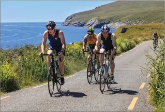  ??  ?? Con O’Regan, Cathal King and David O’Leary, cycling along the coast of Valentia Island, Co Kerry.