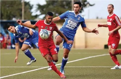  ?? Photo: Domenic Aquilina ?? Victor Hugo Dos Santos of Fgura United (second left) shields the ball away from the challenge of Neil Pace Cocks of Pieta’ Hotspurs (second right)