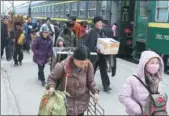  ?? JIANG HONGJING / XINHUA ?? Passengers get off a train in Xide county, Sichuan province, on Saturday. Ticket prices for the train have remained unchanged for more than 20 years amid government poverty relief efforts.