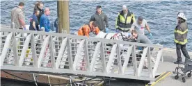  ?? Photo / AP ?? Emergency response crews transport an injured passenger to an ambulance in Ketchikan, Alaska.