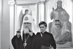  ?? Associated Press ?? ■ In this handout photo released by the Russian Orthodox Church Press Service, Patriarch Kirill presides over a meeting of the church's Holy Synod of the Russian Orthodox Church on Friday in Moscow. The meeting of the church's top hierarchs mulled a response to a decision by Orthodox Christiani­ty's leading body to send two envoys to Ukraine.