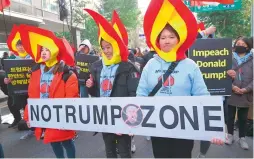  ?? —AFP ?? South Korean protestors hold a banner reading “No Trump Zone,” during an antiTrump rally in Seoul on Saturday.