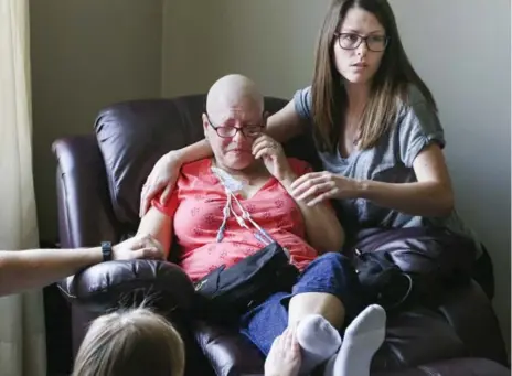  ?? ANDREW FRANCIS WALLACE/TORONTO STAR ?? Sharon Shamblaw is comforted by her daughter Amanda at her family home in St. Marys, Ont. The mother of three is in palliative care.