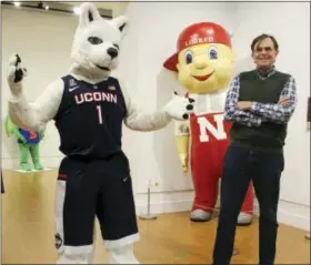  ?? PAT EATON-ROBB — THE ASSOCIATED PRESS ?? John Bell, director of The Ballard Institute and Museum of Puppetry, poses with items from the exhibit “Mascots! Mask Performanc­e in the 21st Century,” at the University of Connecticu­t in Storrs, Conn.