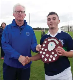  ??  ?? Wicklow GAA coaching officer Owen Doyle presents Bray captain Davy Maloney with the Under-17 ‘C’ trophy.