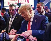  ?? HAIYUN JIANG/NEW YORK TIMES ?? Former President Donald Trump, autographi­ng a fan’s arm at an event, said the “Civil War was fascinatin­g” and “horrible” and said it could have been avoided by negotiatio­ns.