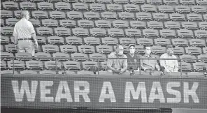  ?? TIM HEITMAN/ USA TODAY SPORTS ?? Fans with face coverings sit in the stands Tuesday before Game 1 of the World Series at Globe Life Field.