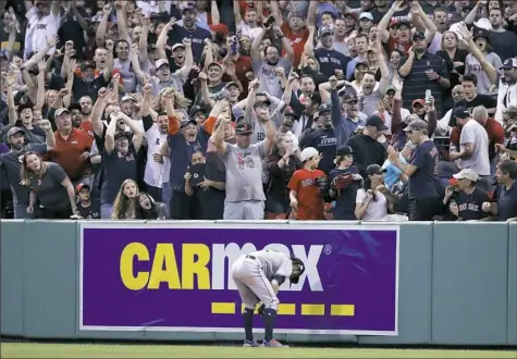  ?? Charles Krupa/Associated Press ?? Houston right fielder Josh Reddick reacts after a ball hit by Boston's Jackie Bradley Jr. popped out of his glove and over the fence for a three-run home run in the seventh inning Sunday in Boston.