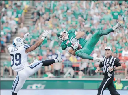  ?? — CP FILES ?? Saskatchew­an Roughrider­s receiver Ryan Smith, right, makes an acrobatic grab against the Toronto Argonauts Sunday in Regina. Smith has been a surprising bright spot for the winless Riders.