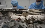  ?? NASA ?? Astro-materials processors collect particles of the asteroid Bennu from the base of the OSIRIS-REx sample canister.